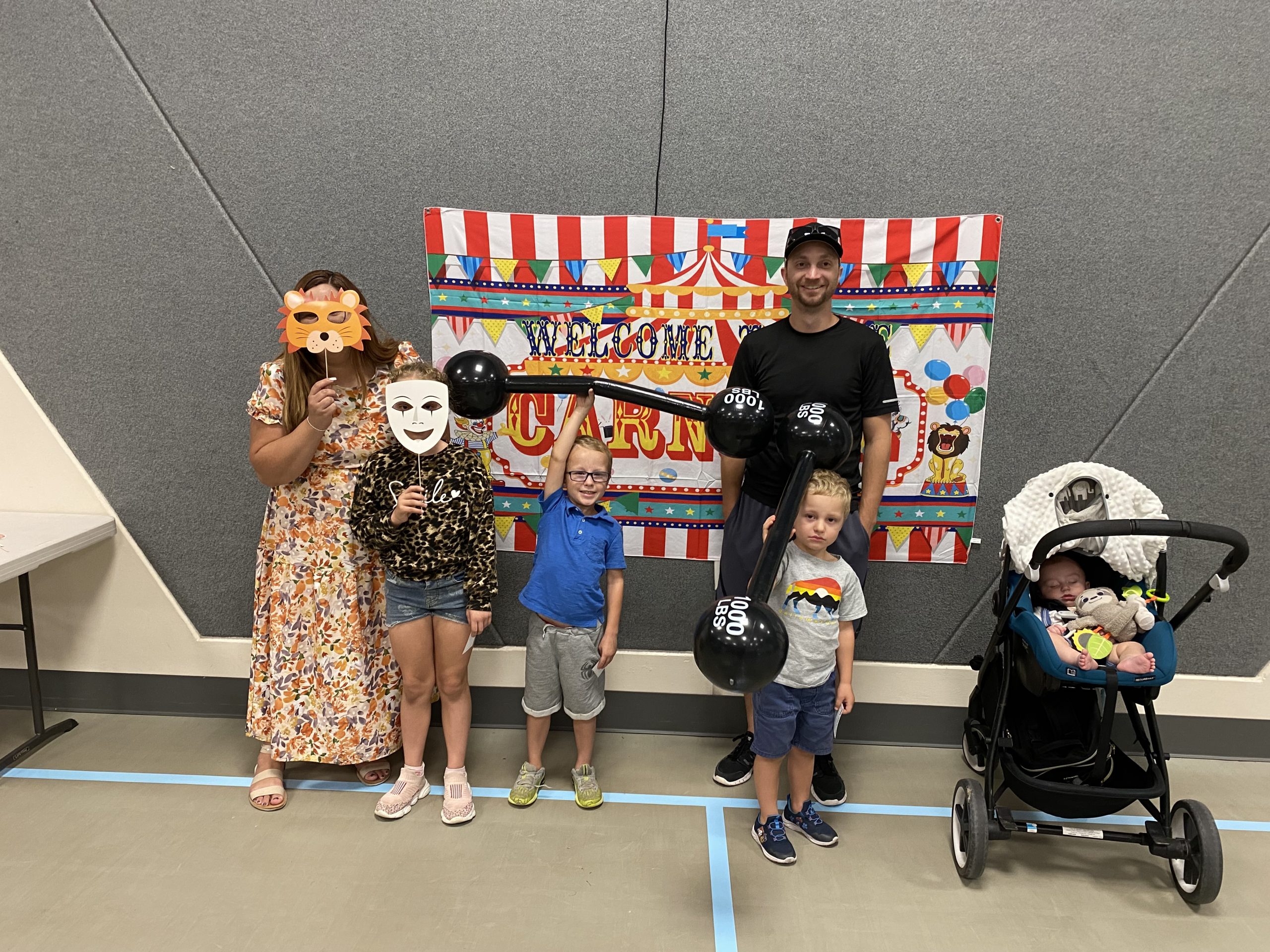 A family of six people with props at Literacy Night