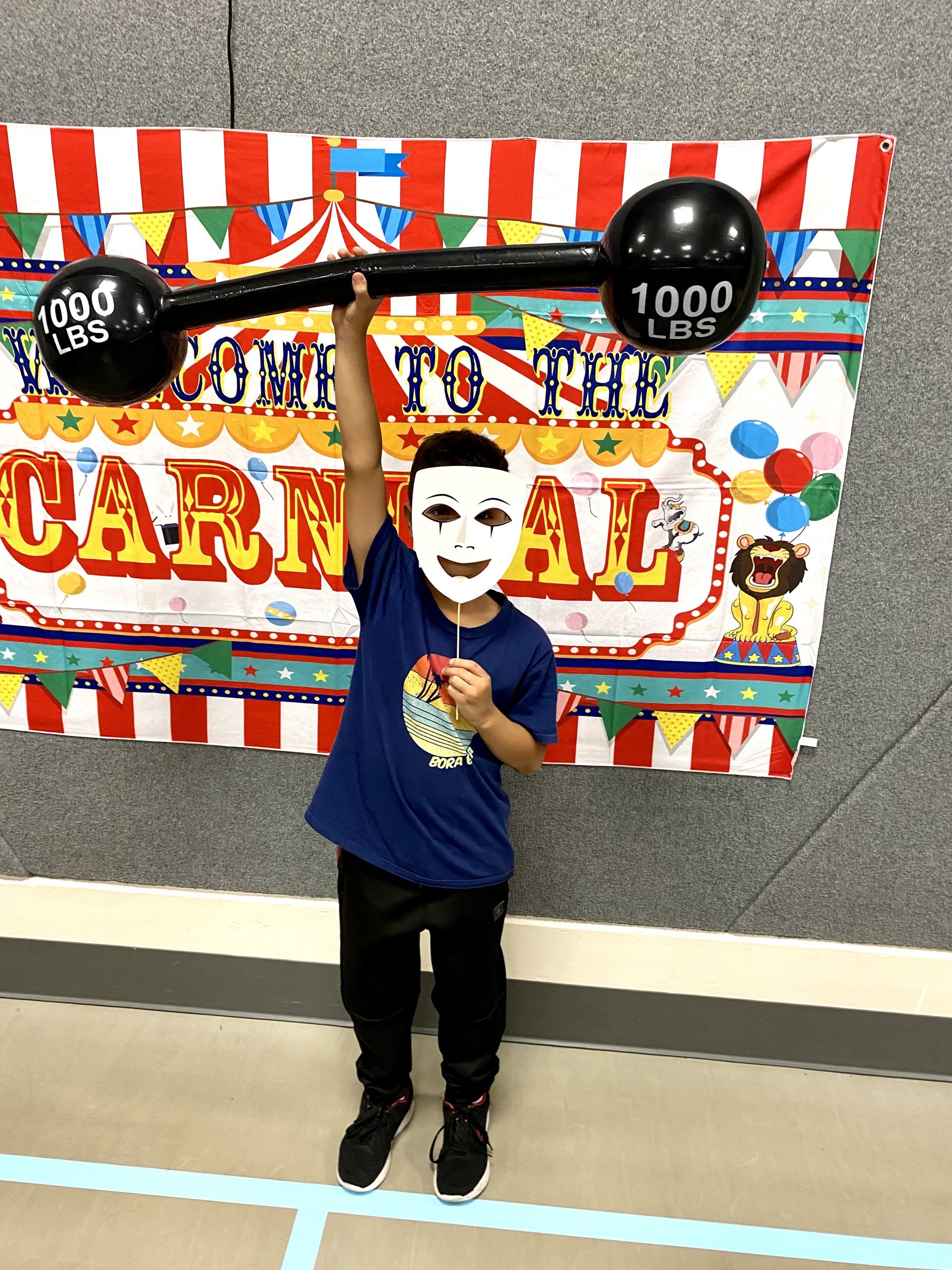 A student holding circus props at Literacy Night
